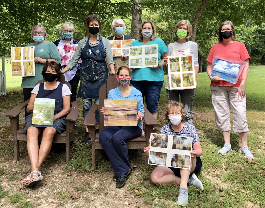 A group of women and their finished artworks